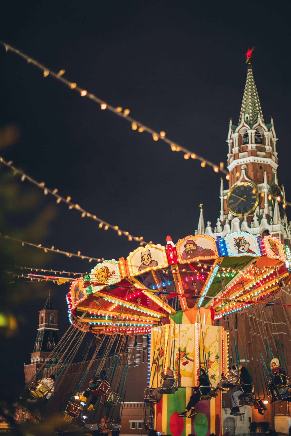 a colorfully lit carousel at night